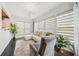 Relaxing sunroom featuring a white sectional sofa, recliner, and bright natural lighting at 130 W Pier Way, Fayetteville, GA 30214