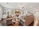 Cozy living room featuring a stone fireplace, built-in bookshelves, and dark hardwood floors at 130 W Pier Way, Fayetteville, GA 30214