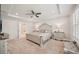 A serene primary bedroom suite featuring tray ceiling, plantation shutters, and ensuite bath at 130 W Pier Way, Fayetteville, GA 30214