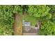 Aerial view showing a large property with wooded surroundings, a multi-level deck, and a long driveway at 305 Devilla Trce, Fayetteville, GA 30214