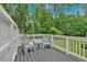 Charming deck with seating offers a cozy spot for outdoor relaxation, surrounded by lush greenery and natural beauty at 305 Devilla Trce, Fayetteville, GA 30214