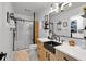 Modern bathroom featuring walk-in shower, black finishes, and stylish vanity at 305 Devilla Trce, Fayetteville, GA 30214