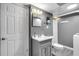 Updated bathroom features a stylish vanity, framed mirror, and modern fixtures; a blend of comfort and design at 305 Devilla Trce, Fayetteville, GA 30214