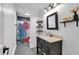 Modern bathroom with decorative shower curtain, stylish vanity, and open shelving at 305 Devilla Trce, Fayetteville, GA 30214