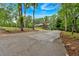 Long driveway leading to a charming home, surrounded by mature trees and lush landscaping at 305 Devilla Trce, Fayetteville, GA 30214