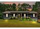 Charming single-story home with covered front porch, manicured lawn, and mature trees at sunset at 305 Devilla Trce, Fayetteville, GA 30214