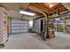 Large storage space with a garage door, ping pong table, shelving, and utilities, providing ample organization and function at 305 Devilla Trce, Fayetteville, GA 30214