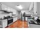Modern kitchen with stainless steel appliances, black countertops, and plenty of cabinet space at 305 Devilla Trce, Fayetteville, GA 30214