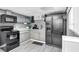Modern kitchen with black appliances, ample cabinet space, and bright countertops at 305 Devilla Trce, Fayetteville, GA 30214