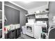 Well-organized laundry room with modern washer and dryer, storage shelves, and sleek decor at 305 Devilla Trce, Fayetteville, GA 30214