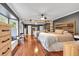 Serene bedroom retreat with beautiful hardwood floors, a large mirrored closet, and natural light at 305 Devilla Trce, Fayetteville, GA 30214