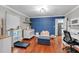 Well-lit office space features hardwood floors, blue accent wall, and lots of storage at 305 Devilla Trce, Fayetteville, GA 30214