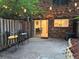 Cozy backyard patio with string lights, surrounded by a wood fence and brick exterior at 3119 Colonial Way # H, Atlanta, GA 30341