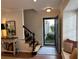 Entryway featuring a staircase with black banister, open door, and a sun-filled seating nook at 3119 Colonial Way # H, Atlanta, GA 30341