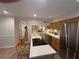 Kitchen with stainless steel appliances, light countertops, adjacent seating and view into the living room at 3119 Colonial Way # H, Atlanta, GA 30341