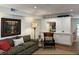 Cozy living room features a comfortable sofa, accent chair, and built-in shelving with pass-through to the kitchen at 3119 Colonial Way # H, Atlanta, GA 30341