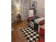 Cozy bedroom features warm wood floors, plaid accents, and plenty of natural light, creating an inviting retreat at 313 India Ln, Canton, GA 30114