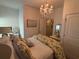 Bedroom featuring chandelier, light blue walls, and a door to the bathroom at 313 India Ln, Canton, GA 30114