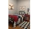 Cozy bedroom features warm wood floors, plaid accents, and plenty of natural light, creating an inviting retreat at 313 India Ln, Canton, GA 30114