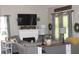 Cozy living room featuring a fireplace, comfortable seating, and stylish decor with checkered accents and greenery at 313 India Ln, Canton, GA 30114