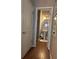 Charming powder room featuring pedestal sink, round mirror, and hardwood floors at 313 India Ln, Canton, GA 30114