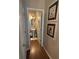 Charming powder room featuring pedestal sink, round mirror, and hardwood floors at 313 India Ln, Canton, GA 30114