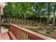 Landscaped backyard with terraced garden, mature trees, and a charming swing, creating a serene outdoor oasis at 4561 Jenkins Way, Douglasville, GA 30135