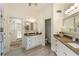 Elegant bathroom with double vanities, stone countertops, and decorative mirrors, adding sophistication and style at 4561 Jenkins Way, Douglasville, GA 30135