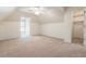 Spacious bedroom featuring neutral carpet, sloped ceiling, ceiling fan, window, and walk-in closet at 4561 Jenkins Way, Douglasville, GA 30135