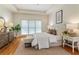 Calm bedroom boasts a tray ceiling, hardwood floors, and large windows, creating a serene and inviting space at 4561 Jenkins Way, Douglasville, GA 30135