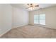Bedroom featuring neutral carpet, ceiling fan, and a window at 4561 Jenkins Way, Douglasville, GA 30135
