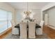 Bright dining room with hardwood floors, chandelier, and a large window at 4561 Jenkins Way, Douglasville, GA 30135