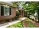 Close-up of a lovely brick home with lush landscaping and a charming walkway leading to the front door at 4561 Jenkins Way, Douglasville, GA 30135
