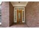 Charming brick home featuring a front door with decorative glass sidelights and transom at 4561 Jenkins Way, Douglasville, GA 30135