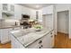 Bright kitchen with marble island, stainless appliances, white cabinets, and herringbone backsplash at 4561 Jenkins Way, Douglasville, GA 30135