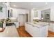 Charming kitchen featuring white cabinets, stainless appliances, and center island with marble countertop at 4561 Jenkins Way, Douglasville, GA 30135