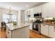 Bright kitchen with island, stainless steel appliances, and a small eating area at 4561 Jenkins Way, Douglasville, GA 30135