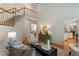 Open living room with stairs leading to second floor and view into kitchen at 4561 Jenkins Way, Douglasville, GA 30135