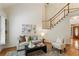Comfortable living room with two-story ceilings and hardwood floors at 4561 Jenkins Way, Douglasville, GA 30135