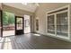 Inviting screened porch with wood flooring and view of backyard, perfect for enjoying the outdoors in comfort at 4561 Jenkins Way, Douglasville, GA 30135