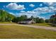 Aerial view of a property featuring a barn-style house, shed, and lush greenery at 540 Benton Rd, Covington, GA 30014