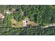 Expansive aerial view showcasing the property nestled amongst lush greenery with a private pool and ample space at 540 Benton Rd, Covington, GA 30014