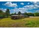 Expansive aerial view of the property, featuring a home, fenced pasture, and lush greenery at 540 Benton Rd, Covington, GA 30014