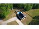 A captivating aerial perspective of a house with a pool, gazebo, and private driveway in a serene, wooded setting at 540 Benton Rd, Covington, GA 30014