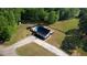 Scenic aerial view of house with pool, gazebo, long driveway and fenced in yard surrounded by lush greenery and trees at 540 Benton Rd, Covington, GA 30014