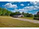 Aerial view of a property featuring a barn-style house, shed, and lush greenery at 540 Benton Rd, Covington, GA 30014