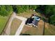 Aerial view of stunning home with a private pool, gazebo, and long driveway, surrounded by lush greenery at 540 Benton Rd, Covington, GA 30014