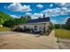 Backyard view with a paved walkway and landscaped garden at 540 Benton Rd, Covington, GA 30014