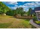 Spacious backyard featuring an outdoor dining area, lush greenery, and an outbuilding at 540 Benton Rd, Covington, GA 30014