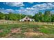 White barn-style home featuring a distinctive gabled roof and wooden accents, set against a serene backdrop at 540 Benton Rd, Covington, GA 30014